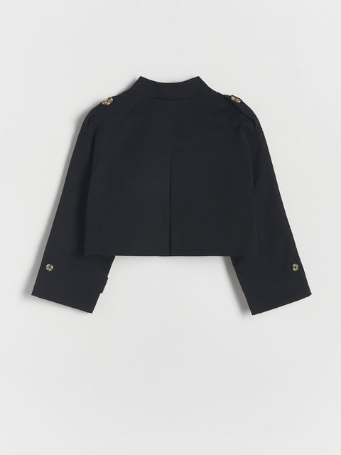 Black cropped jacket with gold buttons on a light gray background