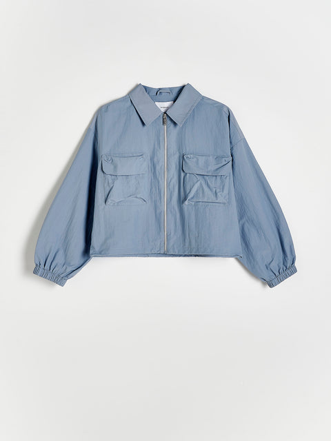 Light blue jacket with two front pockets on a white background