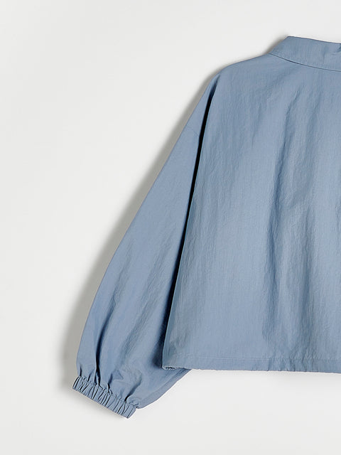 Light blue blouse with balloon sleeves on a white background