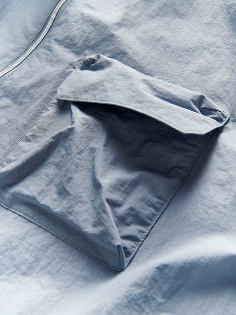 Folded blue fabric on a textured surface