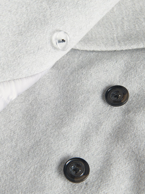 Close-up of a gray fabric surface with buttons