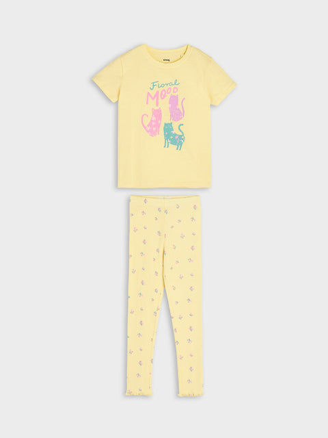 Yellow pajama set with cat designs on a white background
