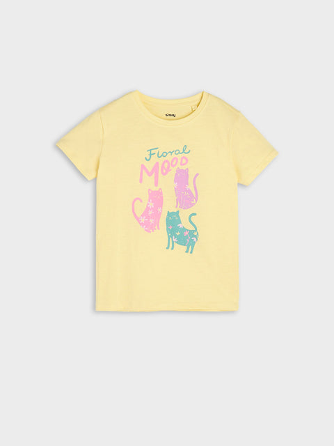 Yellow t-shirt with cat graphics and text on a light gray background
