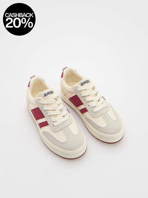 White sneakers with red accents on a white background