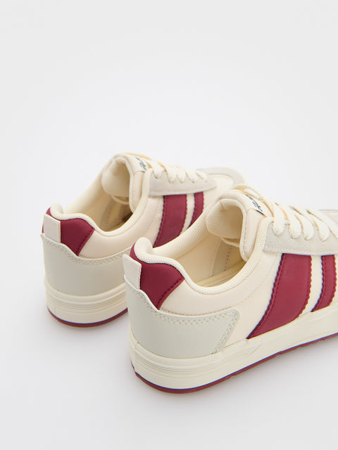 White sneakers with red accents on a white background