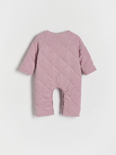 Pink quilted baby romper on a light gray background