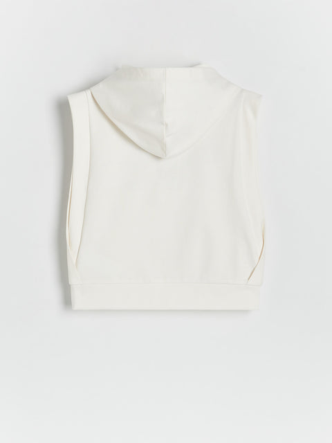 White sleeveless top on a light gray background