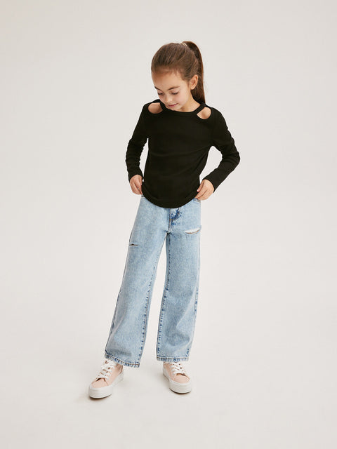Child wearing a black long-sleeve top with cut-out shoulders and light blue jeans on a white background