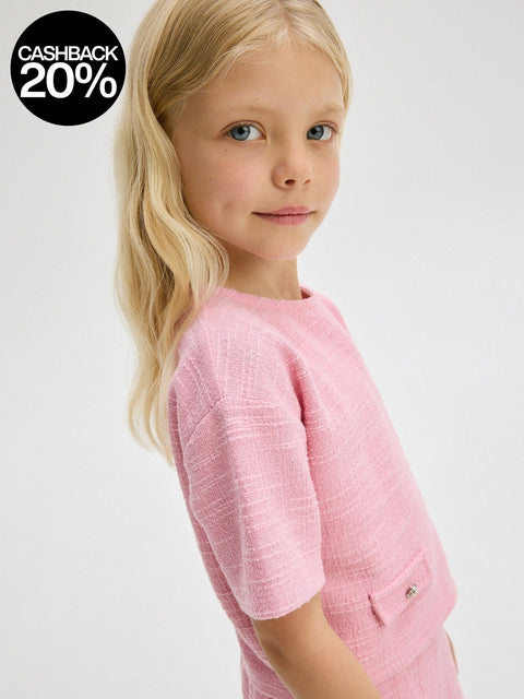 Young girl wearing a pink outfit on a white background