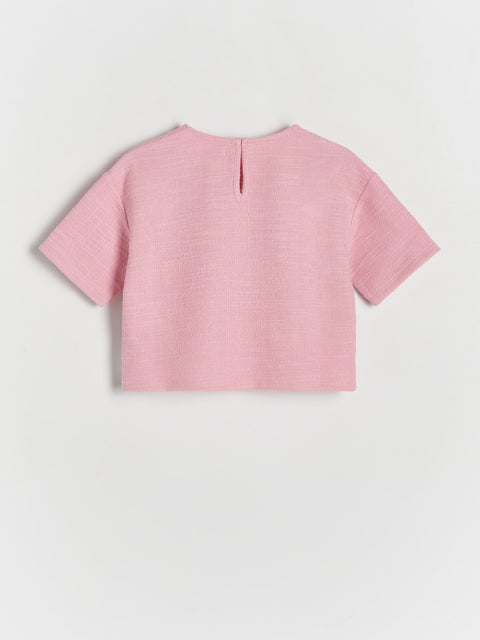 Pink crop top on a light gray background