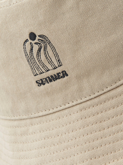 Beige cap with black embroidered logo and text on a beige background