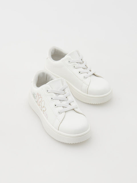 Pair of white sneakers on a light gray background