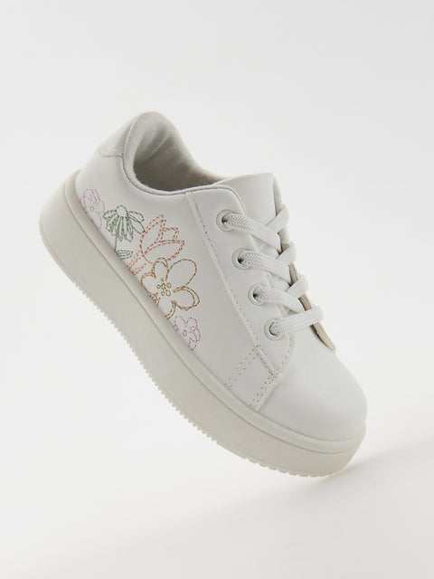 White sneaker with floral design on a white background
