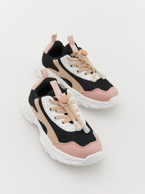 Pair of black, pink, and beige sneakers on a light gray background