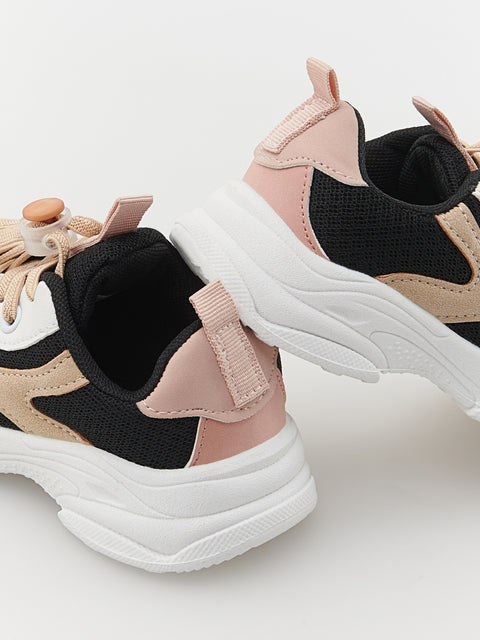 Pair of multicolored sneakers on a light background