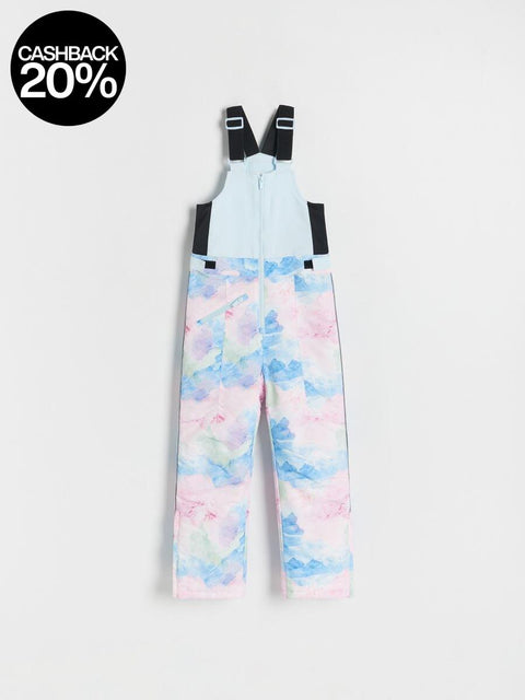 Colorful watercolor patterned bib overalls on a white background