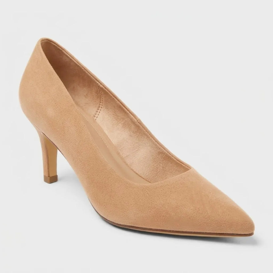 A single women's pointed-toe pump in light tan suede or nubuck, shown from a three-quarters angle on a light gray studio background.