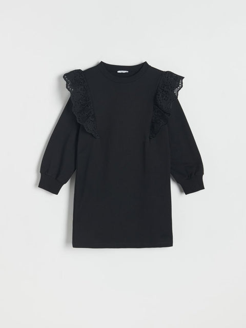 Black dress with lace details on a white background