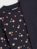 Navy blue garment with pink floral pattern on a white background
