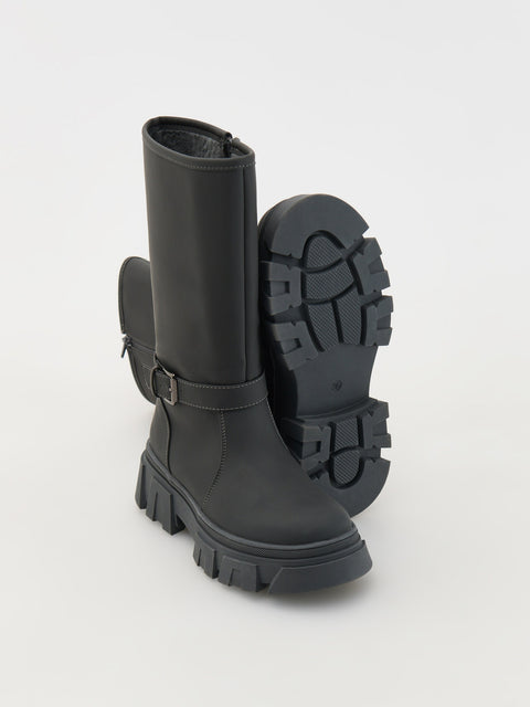 Black rubber boots with a buckle on a light gray background