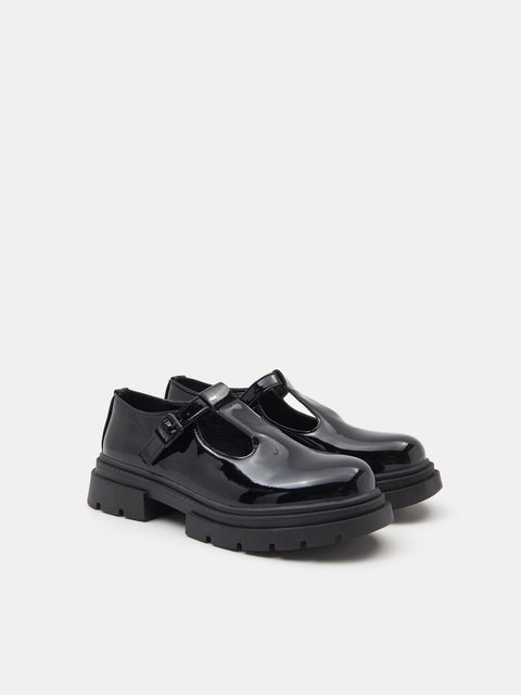 Black shoes with a strap on a white background