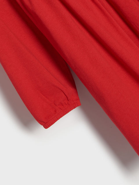 Close-up of a red fabric texture on a white background
