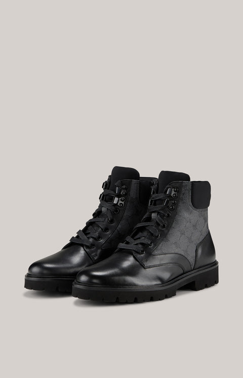 Pair of black and gray high-top boots on a light gray background