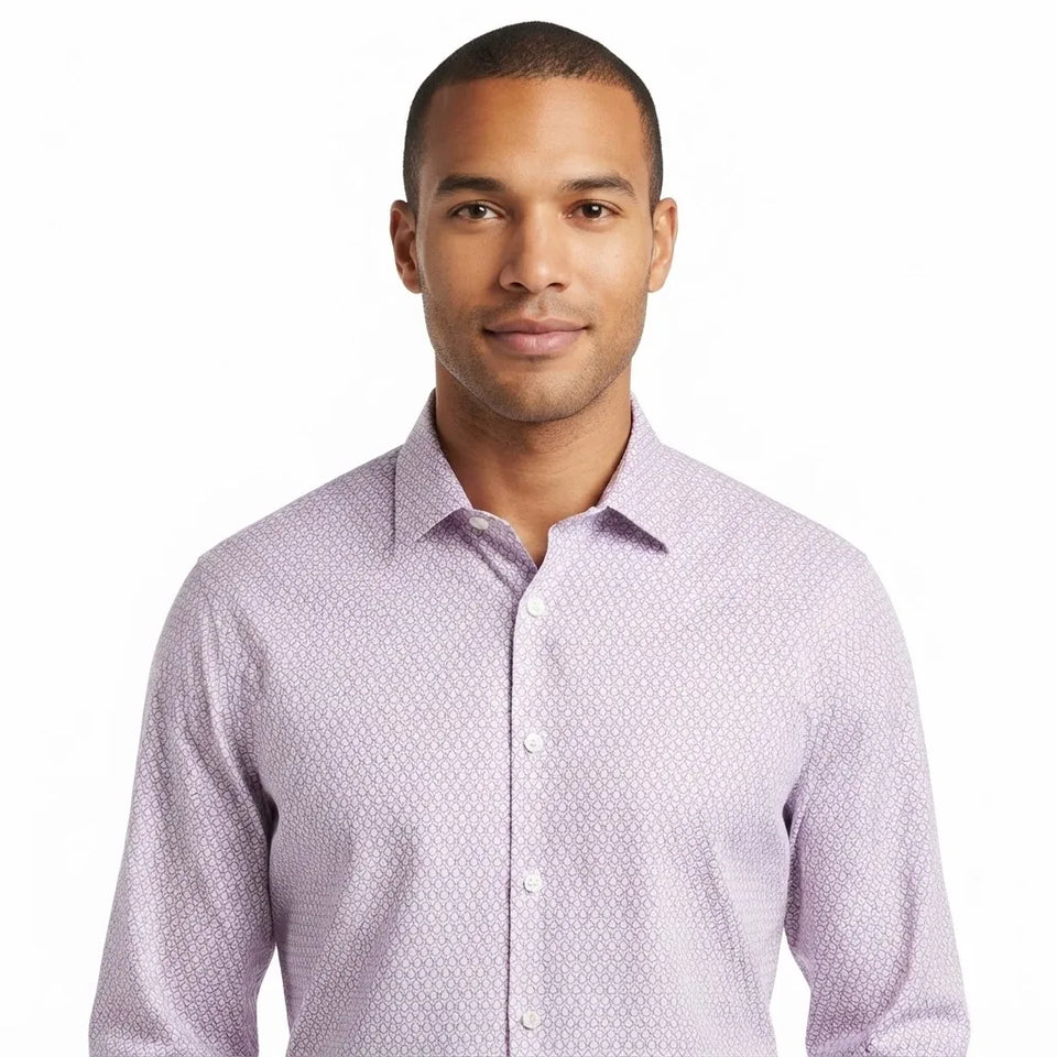 A man wearing a light purple long-sleeve button-down shirt with a subtle geometric pattern, photographed against a solid white background.
