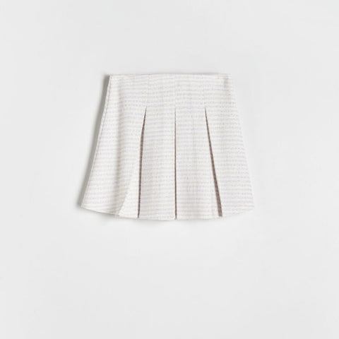 White pleated skirt on a light gray background