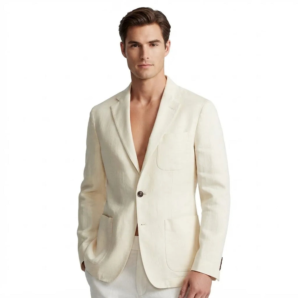 A man wearing a light cream-colored linen blazer with white trousers, photographed against a solid white background.