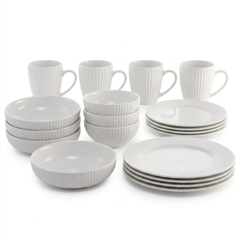 A 16-piece white ceramic dinnerware set with a ribbed texture, including four mugs, four small bowls, four plates, and four shallow bowls, arranged on a white background.