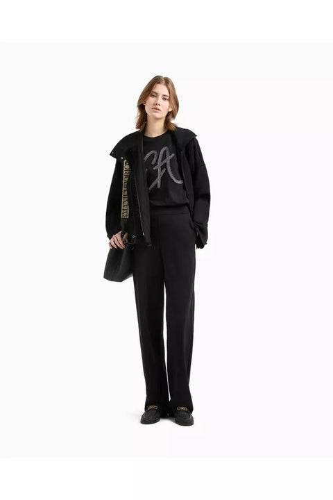 Person wearing a black outfit with a graphic design on a white background
