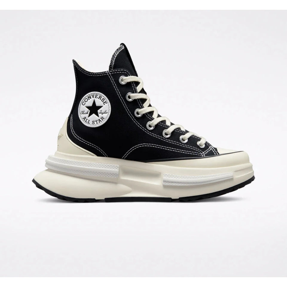 A Converse high-top sneaker in black canvas with a thick cream-colored platform sole, white laces, and the signature circular Converse logo patch on the side.