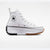 A white Converse All Star high-top sneaker with a chunky platform sole, featuring a black spiked outsole on the heel, a gum-colored spiked outsole on the toe, and the signature circular Converse All Star patch on the side.