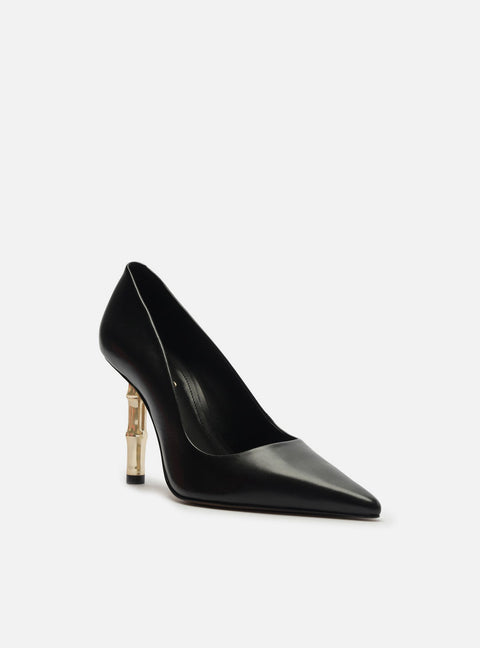 Black high-heeled shoe with a gold heel on a white background