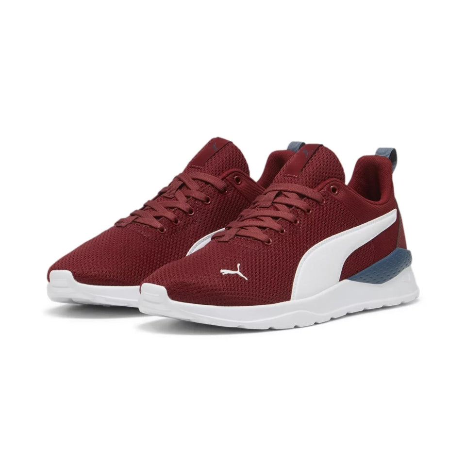 A pair of Puma sneakers in burgundy mesh with a white formstrip and white sole, shown on a clean white background.