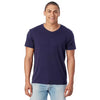 Man wearing a navy blue t-shirt and light blue jeans on a white background
