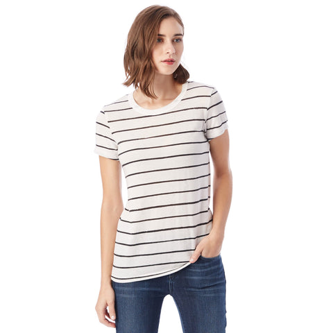 Woman wearing a white and black striped t-shirt with blue jeans on a white background