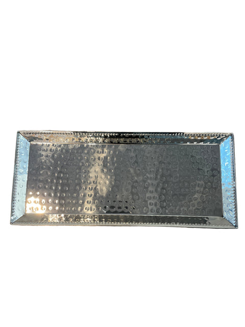 Decorative rectangular mirror with textured surface on a wooden floor