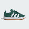 Green Adidas sneaker with white stripes on a light gray background