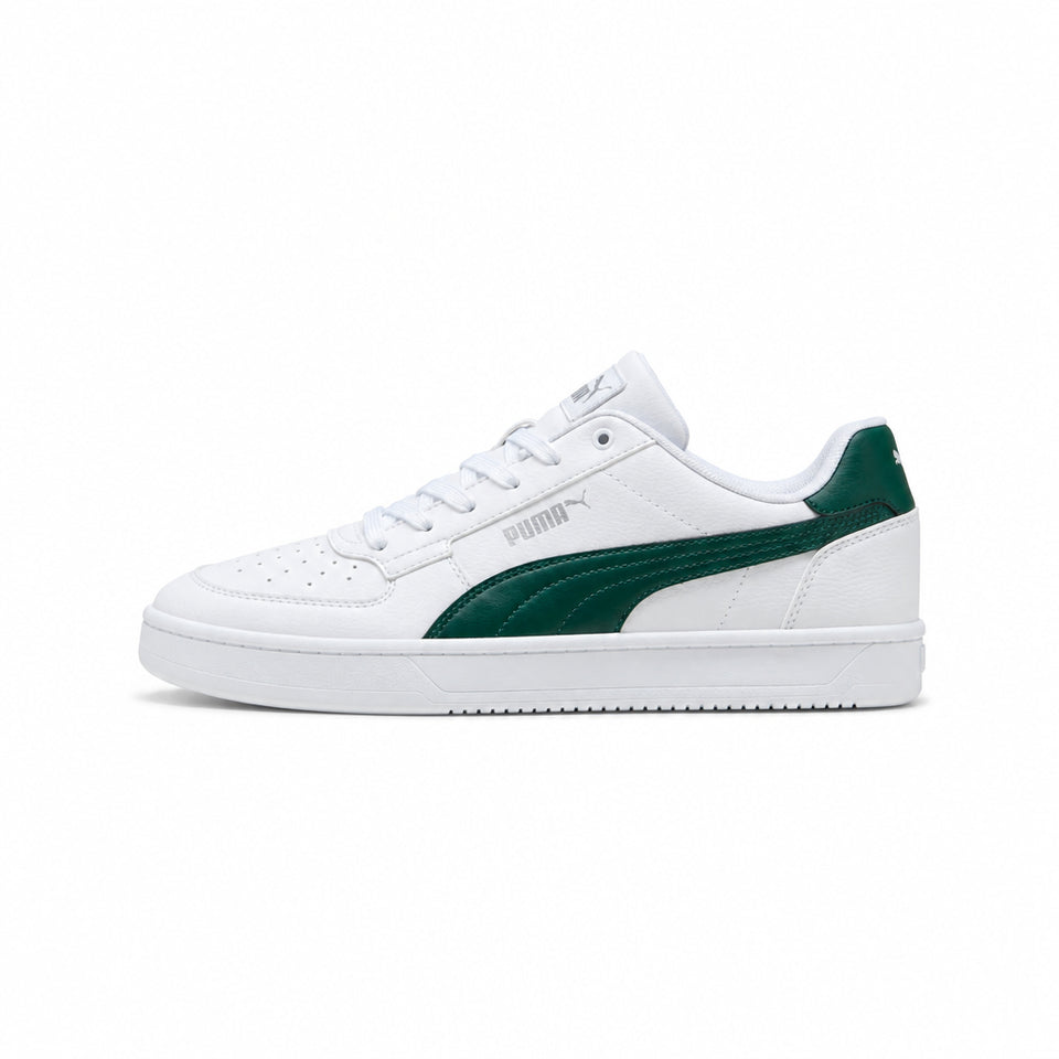 A Puma low-top sneaker in white with a dark green side stripe and heel tab, shown from a side profile on a light gray background.