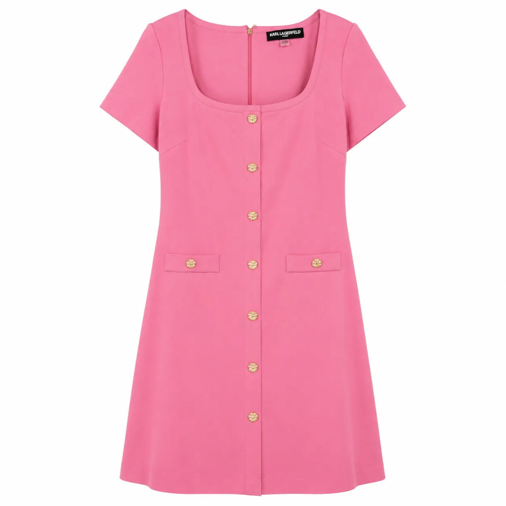 A pink short-sleeve dress with a square neckline, gold-tone front buttons, and two front flap pockets, shown on a plain white background.