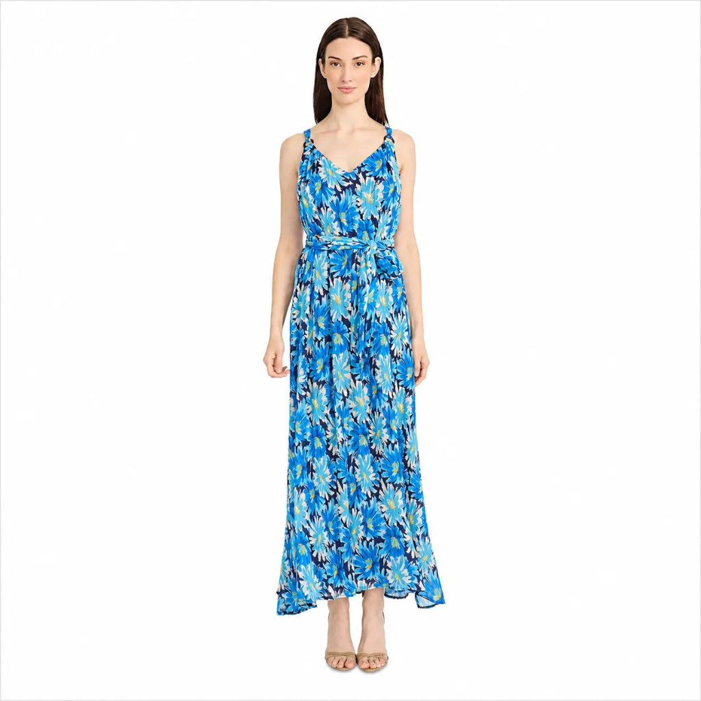 A woman modeling a sleeveless, V-neck maxi dress with a blue and white floral pattern, standing against a plain white background.