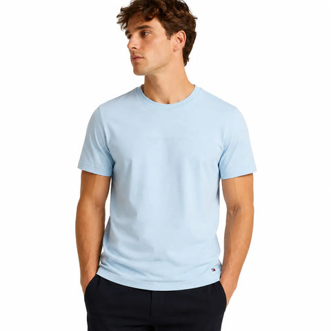 Man wearing a light blue t-shirt on a white background