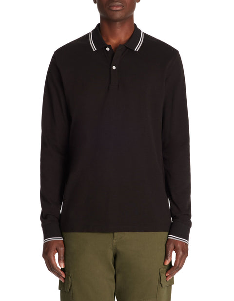 Man wearing a black long-sleeve polo shirt with white trim on a white background
