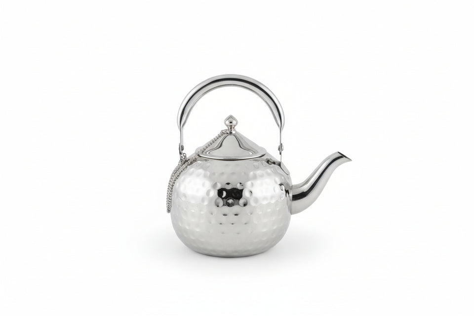 Silver tea strainer on a wooden surface