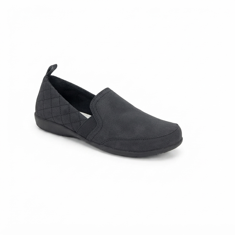 A single black slip-on shoe with a quilted pattern on the heel and a black sole, shown from a three-quarters angle on a white background.