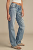 Person wearing blue jeans on a beige background