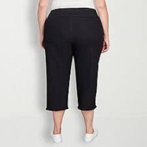 Person wearing black capri pants on a white background