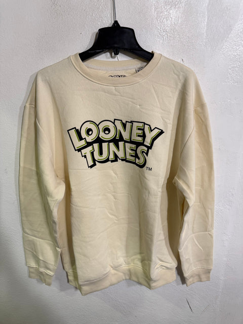 Beige long-sleeve shirt with 'Looney Tunes' logo on a white background